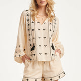 Off White Blouse Met Zwarte Borduursels En Strikkoord | Off White - Black